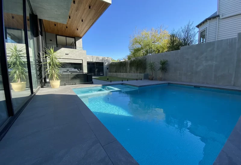 Mooloolaba Project has a lot packed into a small area, granite, tiling, bamboo highlights in a raised garden bed, outdoor BBQ area and glass pool fence, with Tif Tuf lawn